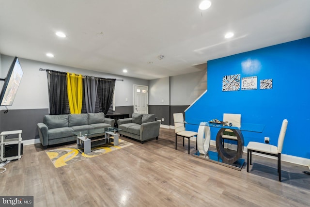 living room with baseboards, wood finished floors, and recessed lighting