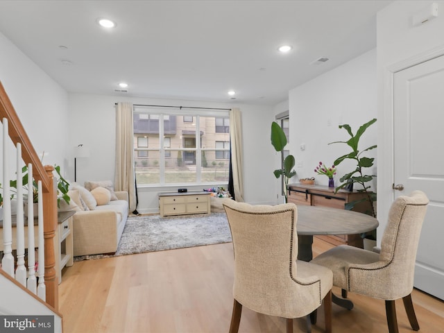 dining area featuring light wood-type flooring, stairs, visible vents, and recessed lighting