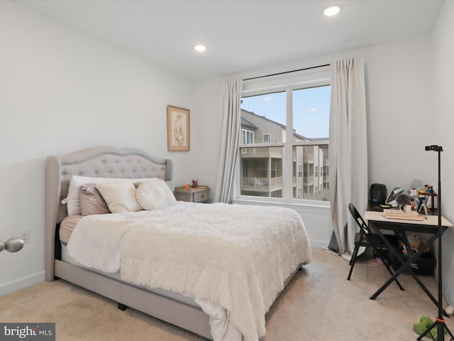 bedroom with recessed lighting, light carpet, and baseboards