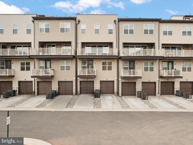 exterior space with central air condition unit and an attached garage