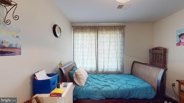 bedroom with multiple windows and visible vents