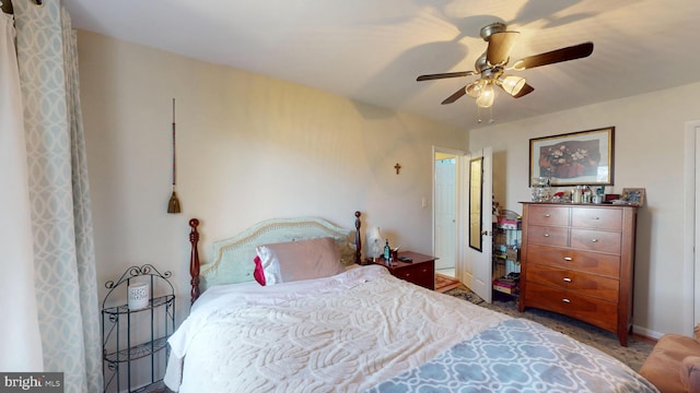 bedroom featuring a ceiling fan and baseboards