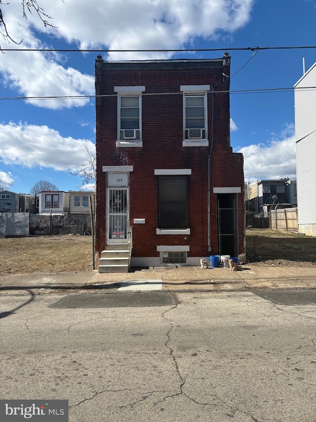 view of front of house with entry steps and brick siding