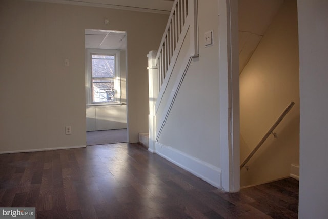 staircase with wood finished floors and baseboards