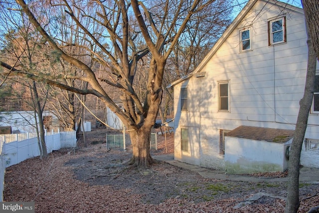 view of home's exterior with fence