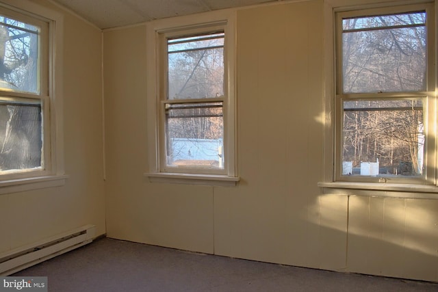 empty room with plenty of natural light and a baseboard radiator