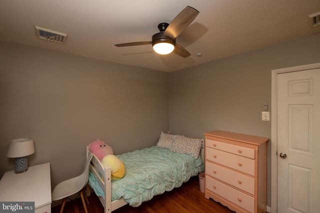 bedroom featuring a ceiling fan, wood finished floors, and visible vents