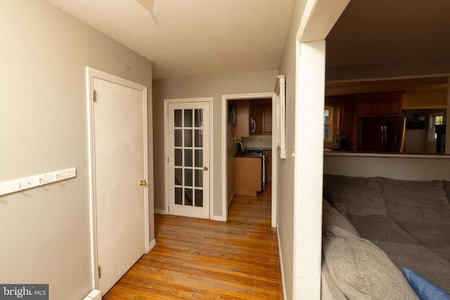 corridor featuring light wood finished floors