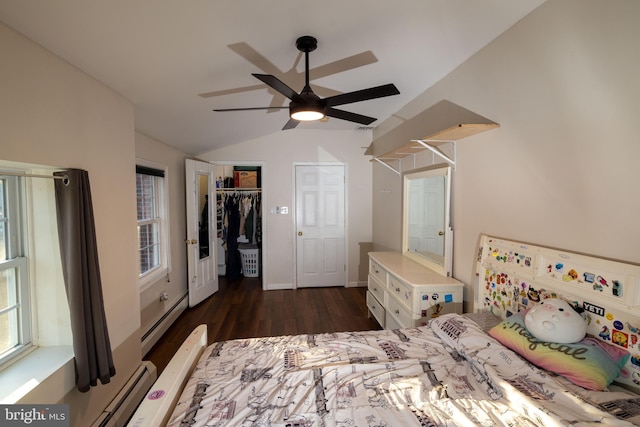 bedroom featuring dark wood-style floors, a closet, lofted ceiling, baseboard heating, and ceiling fan