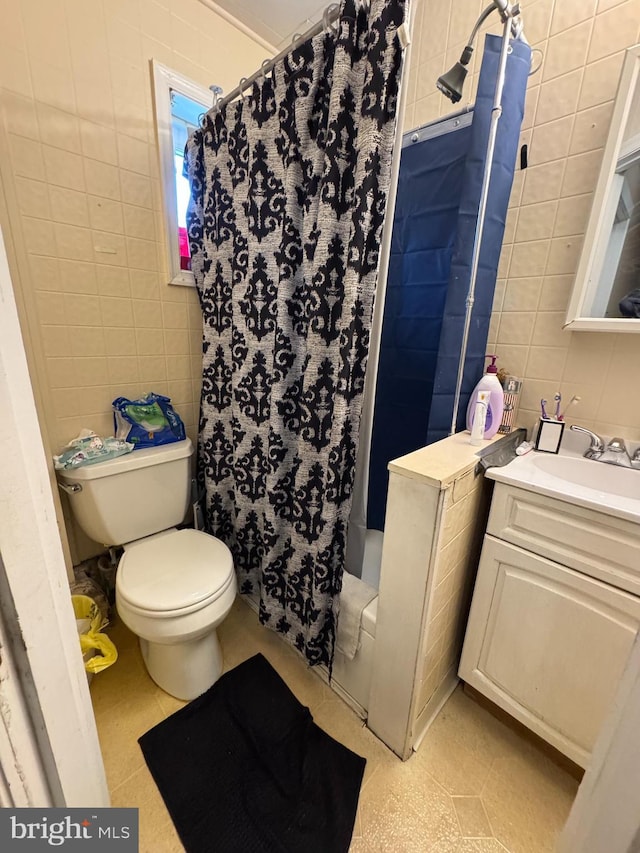 bathroom featuring tile walls, toilet, a shower with shower curtain, vanity, and tile patterned flooring