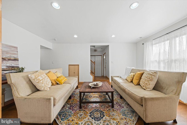 living room with stairway, wood finished floors, and recessed lighting