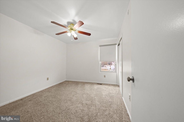 unfurnished bedroom with carpet floors, a ceiling fan, and baseboards