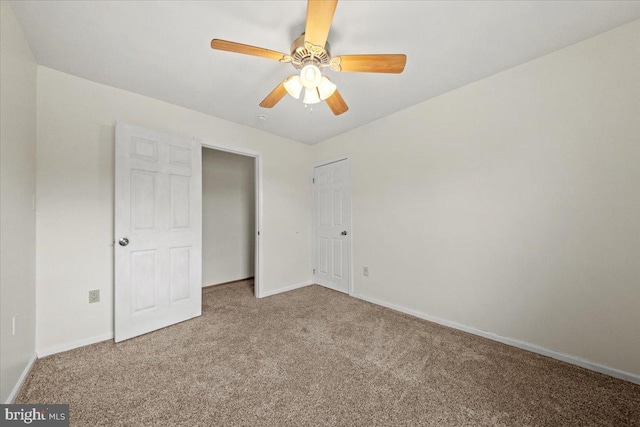 unfurnished bedroom featuring a ceiling fan, a closet, baseboards, and carpet flooring