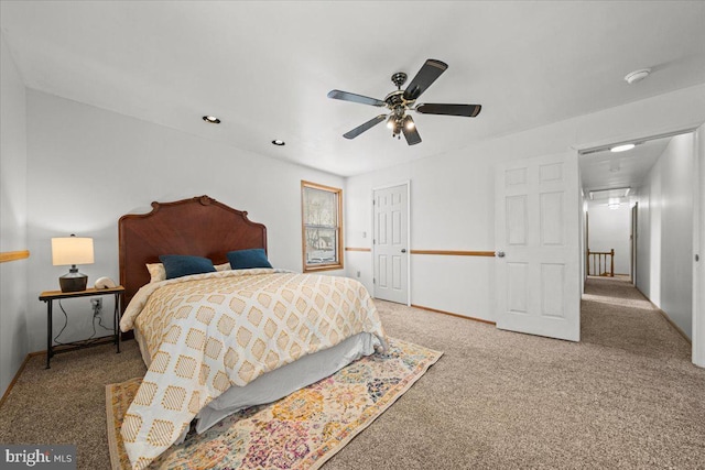 carpeted bedroom featuring a closet, a ceiling fan, and baseboards