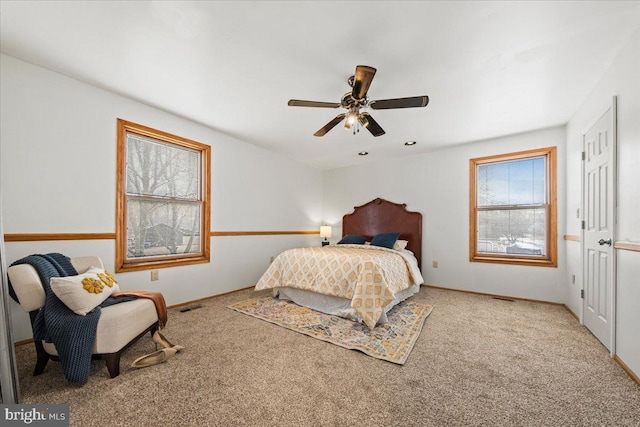 bedroom with carpet floors, visible vents, and a ceiling fan