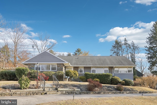 ranch-style house with stone siding