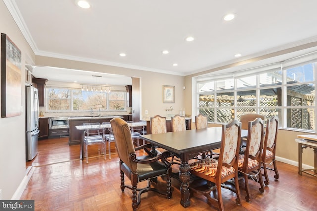 dining space featuring recessed lighting, baseboards, and crown molding