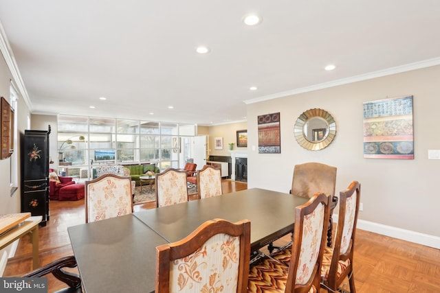 dining area with a fireplace, crown molding, recessed lighting, and baseboards