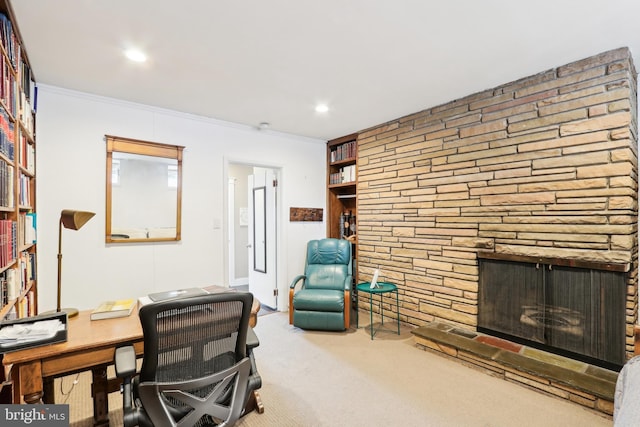 office area featuring crown molding, recessed lighting, a fireplace, and carpet floors