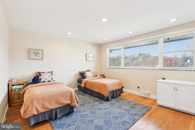 bedroom featuring recessed lighting, wood finished floors, visible vents, and baseboards