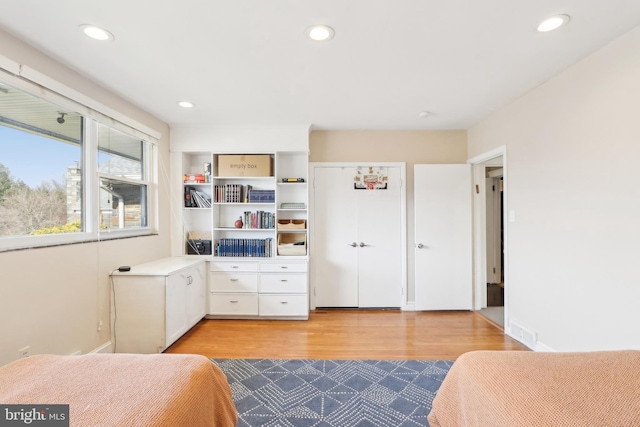 bedroom with visible vents, recessed lighting, light wood-type flooring, and baseboards