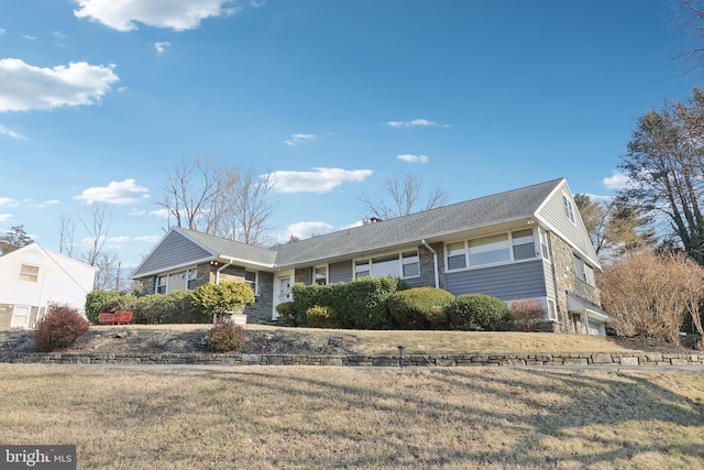 ranch-style home with a front lawn