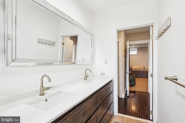 full bath featuring a sink and double vanity