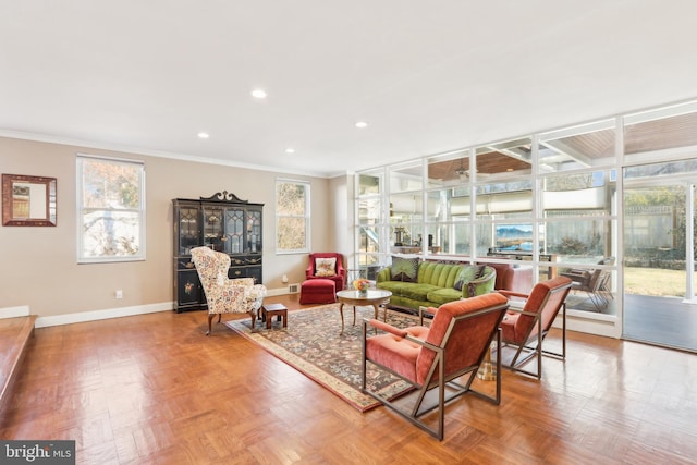 living room featuring plenty of natural light, baseboards, and ornamental molding