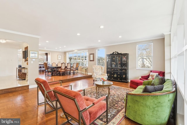 living area with recessed lighting, baseboards, and ornamental molding