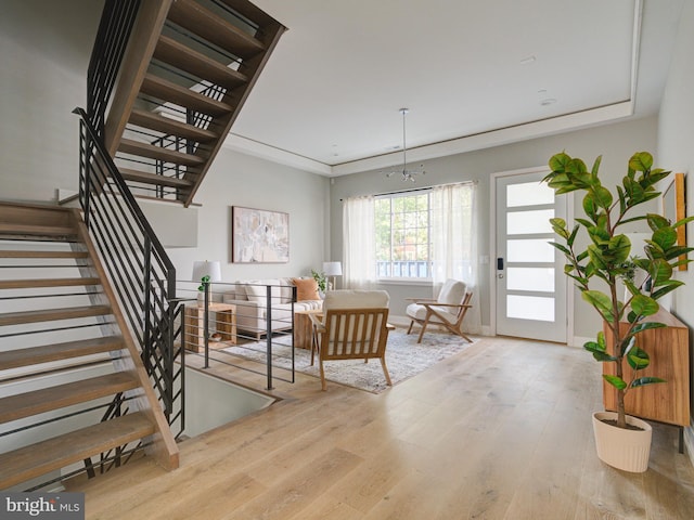 interior space with crown molding, stairway, baseboards, and wood finished floors