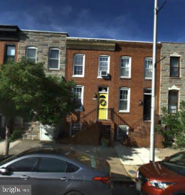 view of property featuring brick siding