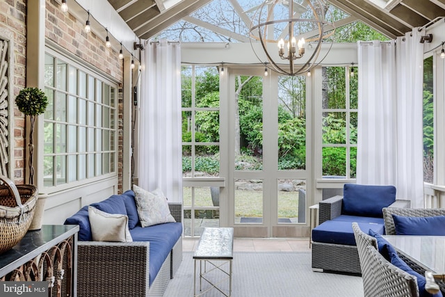 sunroom / solarium with a wealth of natural light, a notable chandelier, and lofted ceiling