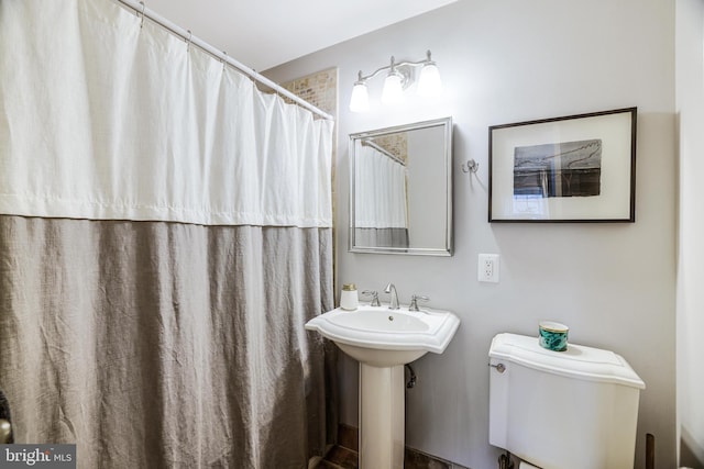 full bathroom featuring toilet and a sink