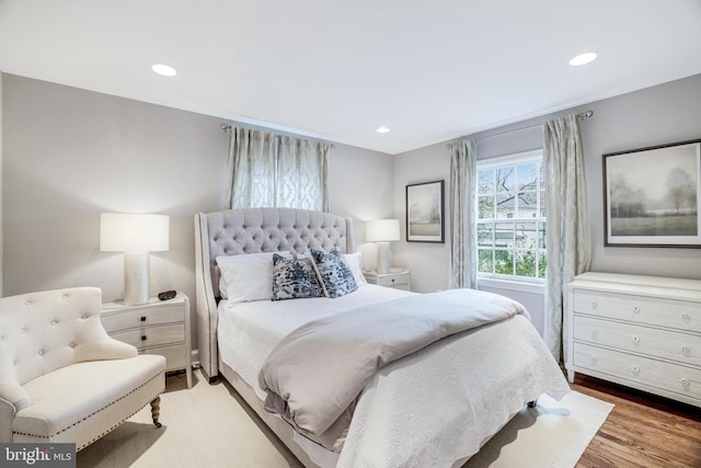 bedroom featuring recessed lighting and wood finished floors