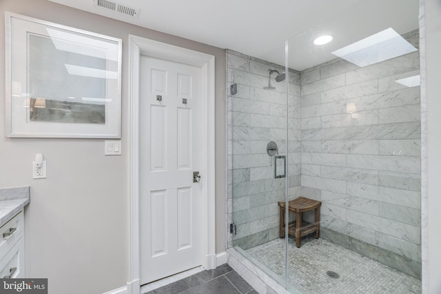 bathroom with visible vents, baseboards, a stall shower, and vanity