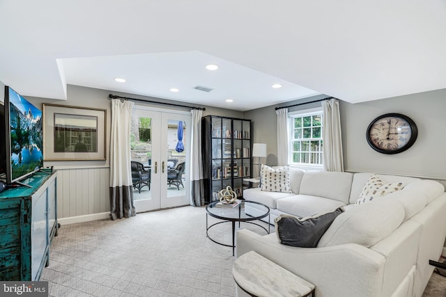 living room featuring wainscoting, visible vents, recessed lighting, and french doors