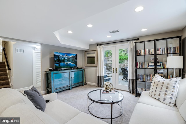 carpeted living area with recessed lighting, visible vents, and stairs