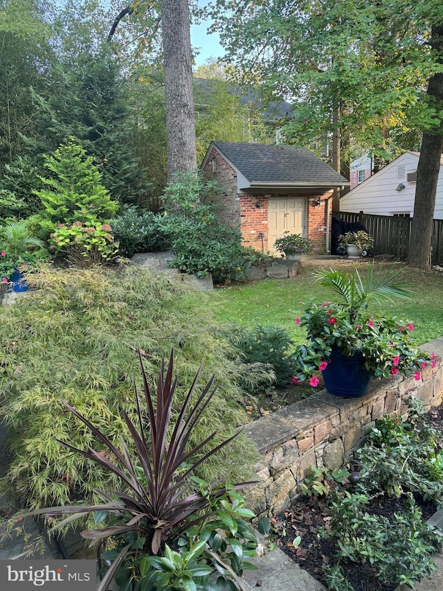 view of yard featuring an outdoor structure and fence