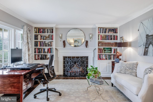 office area with crown molding, a fireplace with flush hearth, and built in features