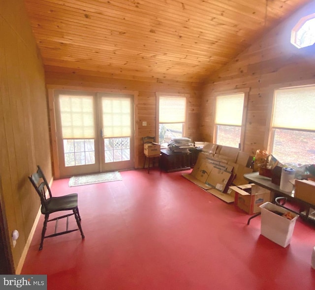 unfurnished room with vaulted ceiling, wood ceiling, and wooden walls