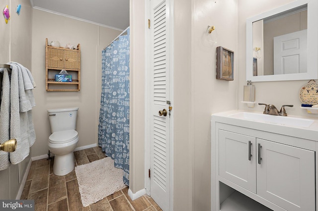 bathroom featuring toilet, vanity, a closet, wood tiled floor, and crown molding