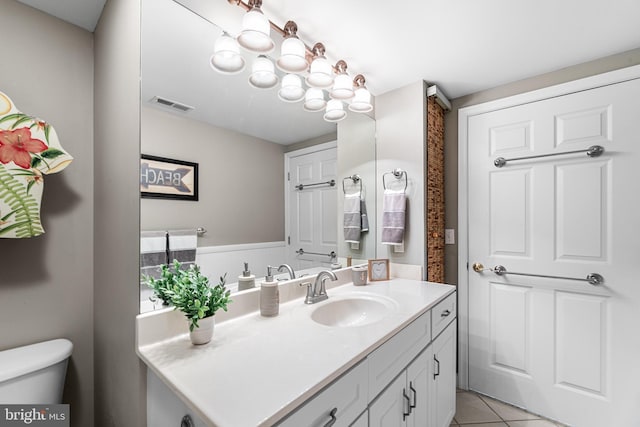 bathroom with toilet, tile patterned floors, visible vents, and vanity