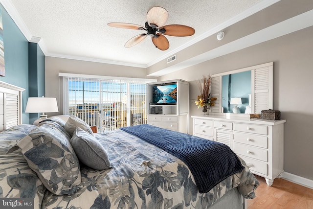 bedroom featuring a textured ceiling, visible vents, access to exterior, ornamental molding, and light wood finished floors