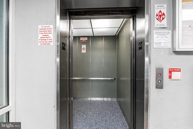 interior details with elevator and a textured wall