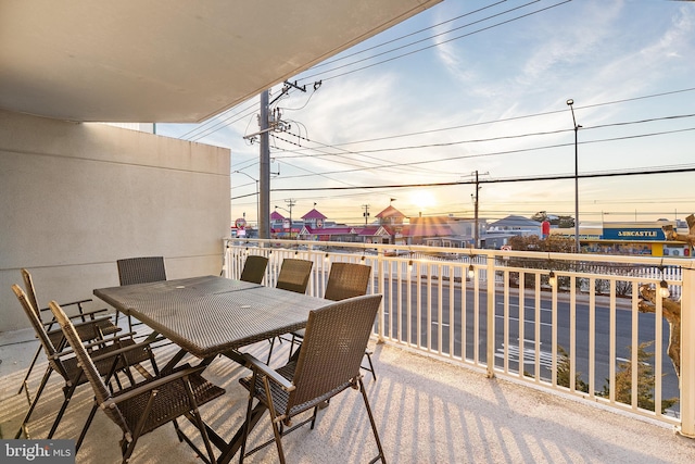 view of patio with a balcony and outdoor dining space