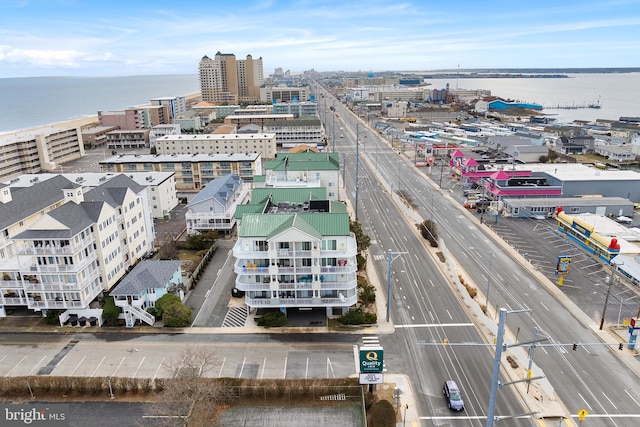 birds eye view of property with a view of city and a water view