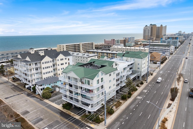 birds eye view of property featuring a water view and a city view