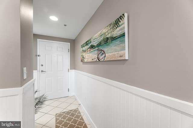 entryway featuring wainscoting and light tile patterned flooring