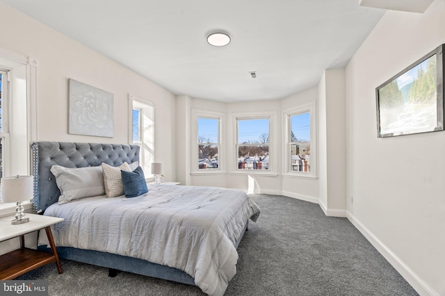 carpeted bedroom featuring visible vents and baseboards