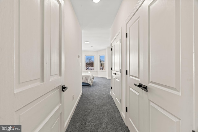 corridor featuring dark colored carpet, baseboards, and recessed lighting